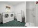 Practical laundry area with washer, dryer, refrigerator, and convenient walk-in shower at 2906 Pemberton Creek Dr, Seffner, FL 33584