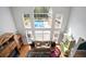 Bright living room boasts high ceilings, large windows, and views of the backyard pool at 2906 Pemberton Creek Dr, Seffner, FL 33584