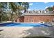 Backyard features a brick home with a pool and patio perfect for outdoor entertaining at 2906 Pemberton Creek Dr, Seffner, FL 33584