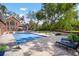Outdoor living space featuring a rectangular pool, patio, and lush landscaping around the home at 2906 Pemberton Creek Dr, Seffner, FL 33584
