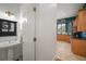Powder room with tiled floor and pedestal sink adjacent to kitchen at 2906 Pemberton Creek Dr, Seffner, FL 33584