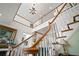 Grand foyer featuring a curved staircase with decorative chandelier at 2906 Pemberton Creek Dr, Seffner, FL 33584