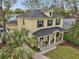 Inviting two-story home with a covered porch, lush landscaping, detached garage and classic architectural details at 2915 W Bay View Ave, Tampa, FL 33611
