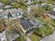An aerial view of a yellow house with a dark roof, mature trees, and inviting outdoor spaces at 2915 W Bay View Ave, Tampa, FL 33611