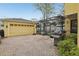 Charming backyard featuring a screened-in pool area, a garage, and a basketball hoop at 2915 W Bay View Ave, Tampa, FL 33611