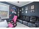 Sports themed bedroom featuring a dark sofa, playful wall art, and large window overlooking the lush yard at 2915 W Bay View Ave, Tampa, FL 33611