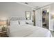 Cozy bedroom features soft lighting, neutral tones, and walk-in closet offer a peaceful retreat at 2915 W Bay View Ave, Tampa, FL 33611