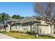 Exterior view of the home with well-maintained landscaping, an attached garage, and architectural details at 2923 Devonoak Blvd, Land O Lakes, FL 34638