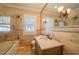 Cozy bathroom featuring tiled walls, updated fixtures, and a glass shower door at 3007 W Angeles St, Tampa, FL 33629