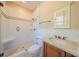 Updated bathroom featuring a tiled shower, updated sink, and bright lighting at 3007 W Angeles St, Tampa, FL 33629