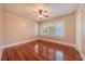 Spacious empty bedroom with hardwood floors, neutral paint, ceiling fan and bright windows at 3007 W Angeles St, Tampa, FL 33629