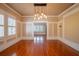 Elegant dining room with hardwood floors, wainscoting, and a modern pendant light fixture at 3007 W Angeles St, Tampa, FL 33629