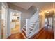 Hallway with hardwood floors leads to the staircase and the bright kitchen at 3007 W Angeles St, Tampa, FL 33629