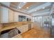 Updated kitchen featuring granite countertops, stainless appliances, and white cabinetry at 3007 W Angeles St, Tampa, FL 33629
