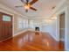 Cozy living room with hardwood floors, a decorative fireplace, and built-in shelving at 3007 W Angeles St, Tampa, FL 33629