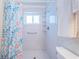 Bright bathroom features a walk-in shower, window and grab bar for safety and convenience at 3010 59Th S St # 314, Gulfport, FL 33707