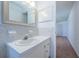 Updated bathroom with tiled backsplash, white vanity, and a large mirror providing an open feel at 3010 59Th S St # 314, Gulfport, FL 33707
