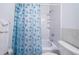 Bathroom with a shower/tub combo and a blue, seashell themed shower curtain at 3010 59Th S St # 314, Gulfport, FL 33707