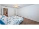 Bright bedroom with carpet, ceiling fan, with connecting door to the bathroom and closet at 3010 59Th S St # 314, Gulfport, FL 33707