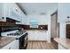 Bright kitchen featuring white cabinetry, laminate countertops and modern appliances at 3010 59Th S St # 314, Gulfport, FL 33707