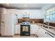 Spacious kitchen with white cabinets, granite countertops, and modern appliances at 3010 59Th S St # 314, Gulfport, FL 33707