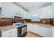 Updated kitchen with white cabinetry, granite countertops, stainless appliances, and ample storage at 3010 59Th S St # 314, Gulfport, FL 33707