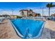 Community swimming pool surrounded by lounge chairs, palm trees, and lush tropical landscaping at 3010 59Th S St # 314, Gulfport, FL 33707