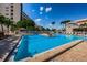 Exterior of the community pool with chairs and umbrellas on a sunny day at 3010 59Th S St # 314, Gulfport, FL 33707