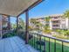 Balcony view of a landscaped community with tropical plants, water features, and multi-story condo buildings at 3021 Countryside Blvd # 23A, Clearwater, FL 33761