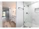 Well-designed bathroom featuring updated vanity and elegant glass-enclosed shower with marble-look tile at 3021 Countryside Blvd # 23A, Clearwater, FL 33761