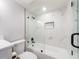Modern bathroom featuring shower over tub and stylish fixtures at 3021 Countryside Blvd # 23A, Clearwater, FL 33761