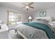 Bright bedroom boasts a ceiling fan, natural light and calming decor at 3021 Countryside Blvd # 23A, Clearwater, FL 33761