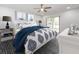 Stylishly decorated bedroom featuring a patterned bedspread, hardwood floors, and bright, natural light at 3021 Countryside Blvd # 23A, Clearwater, FL 33761