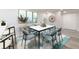 Modern dining room with a white table, blue chairs, and decorative artwork creates an inviting space at 3021 Countryside Blvd # 23A, Clearwater, FL 33761