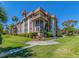 Exterior of condo building featuring balconies, lush landscaping, and well-maintained grounds at 3021 Countryside Blvd # 23A, Clearwater, FL 33761