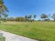 Expansive golf course view with mature trees, manicured lawns, and clear blue skies at 3021 Countryside Blvd # 23A, Clearwater, FL 33761
