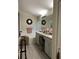 Bathroom with double vanity sinks, soaking tub, and stylish gray cabinets at 3207 Sunwatch Dr, Wesley Chapel, FL 33544