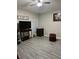 Spacious bedroom with modern gray flooring, a ceiling fan, and neutral paint, offering a blank canvas at 3207 Sunwatch Dr, Wesley Chapel, FL 33544