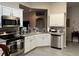 Well-maintained kitchen featuring stainless steel appliances, ample counter space, and white cabinetry at 3207 Sunwatch Dr, Wesley Chapel, FL 33544