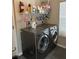 Modern laundry room with front-load washer and dryer, storage shelves, and functional design at 3207 Sunwatch Dr, Wesley Chapel, FL 33544