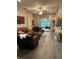 A stylish living room featuring comfortable leather furniture and modern decor at 3207 Sunwatch Dr, Wesley Chapel, FL 33544