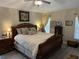 Comfortable and serene main bedroom with decorative accents and hardwood floors at 3207 Sunwatch Dr, Wesley Chapel, FL 33544
