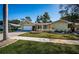 Charming single-story home with manicured lawn, decorative fountain, and a paved driveway leading to the garage at 3531 Glossy Ibis Ct, Palm Harbor, FL 34683