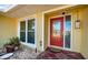 Inviting front door with decorative glass, complemented by a window and small landscaped area at 3531 Glossy Ibis Ct, Palm Harbor, FL 34683