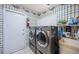 Laundry room with side-by-side washer and dryer for convenient laundry at 3531 Glossy Ibis Ct, Palm Harbor, FL 34683