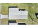 Aerial view of the home's roof, showcasing its size and structure amidst a green, well-maintained lawn at 37246 Eileen Ave, Zephyrhills, FL 33542