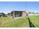 Home exterior featuring a screened-in porch, surrounded by a green lawn, perfect for outdoor enjoyment at 37246 Eileen Ave, Zephyrhills, FL 33542