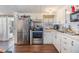 Bright kitchen with stainless steel appliances and wood-look flooring at 37246 Eileen Ave, Zephyrhills, FL 33542
