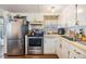 Well lit kitchen with stainless steel appliances and white cabinetry at 37246 Eileen Ave, Zephyrhills, FL 33542