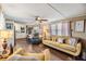 Bright living room with open floor plan, wood-look floors, and cozy furniture at 37246 Eileen Ave, Zephyrhills, FL 33542